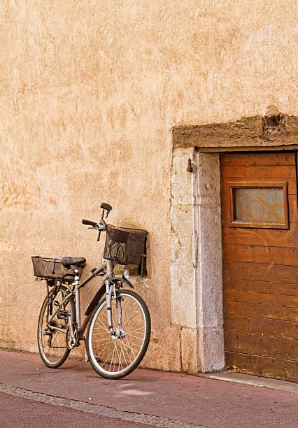 istock bicycle leaning against terracotta coloured wall 488249060
