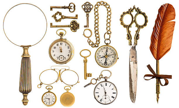 Collection of golden vintage accessories and antique objects Collection of golden vintage accessories and antique objects. Old keys, clock, loupe, compass, ink feather pen, scissors, glasses isolated on white background vintage gold jewelry stock pictures, royalty-free photos & images