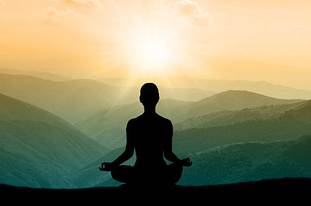istock Yoga silhouette on the mountain in sunrays 488249354