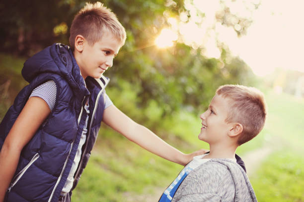 istock Happy boys talking outdoors 488249988