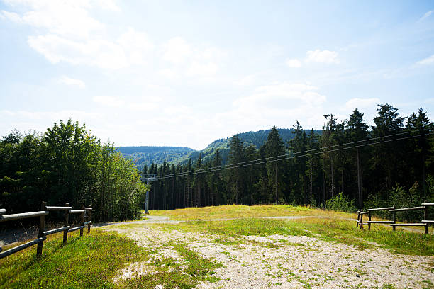 View down ski pist with ski lift in outskirts of Winterberg in summer, Sauerland, North Rhine Westfalia.