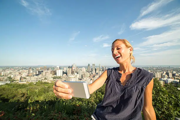 Photo of Student in Montreal taking selfie portrait with mobile phone