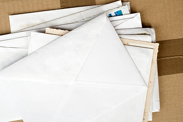 pile of letters and postal parcel pile of letters and postal parcel correspondence stock pictures, royalty-free photos & images