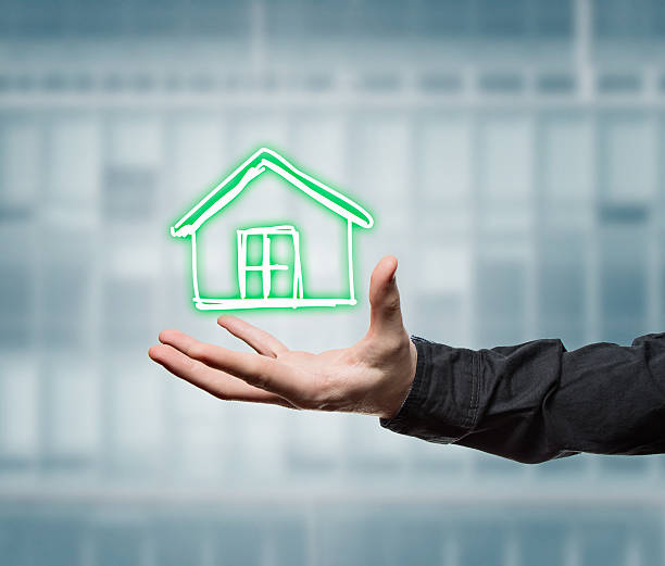 istock Businessman holding a virtual house 488254436