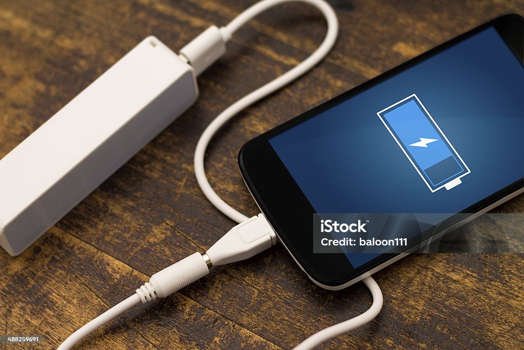 Phone charging with energy bank. Phone charging with energy bank. Depth of field on Power bank Battery Stock Photo