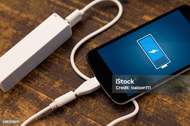 Phone Charging With Energy Bank Stock Photo - Download Image Now - Battery, Blue, Blurred Motion