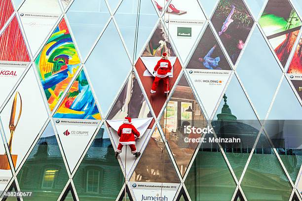 Two Climber Dresses As Santa Claus Climb Down The Facade Stock Photo - Download Image Now