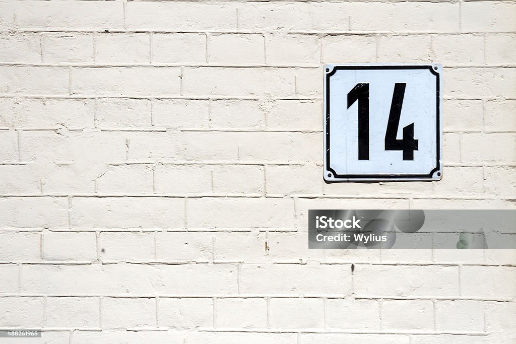 Number 14 on a wall Number 14 on textured brick wall Memorial Plaque Stock Photo