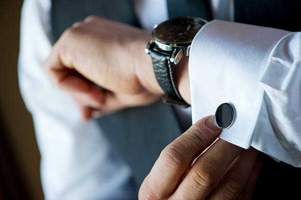 Getting Ready Man doing up his cufflink cufflink stock pictures, royalty-free photos & images