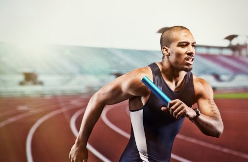 Track and field athlete running with relay batonhttp://www.twodozendesign.info/i/1.png