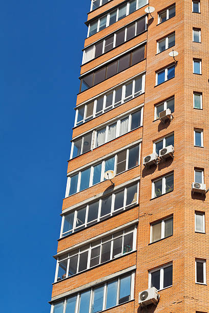 istock blue sky and wall of multistorey house 488265121