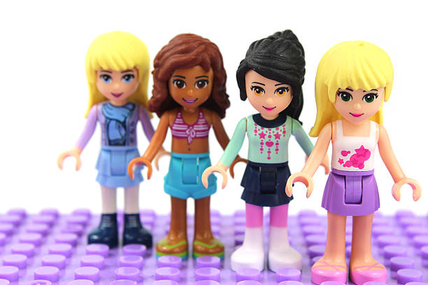 Four Lego Friends on lilac lego base board stock photo