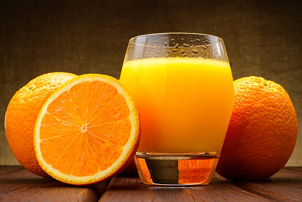 istock glass of Orange juice and oranges 488266367