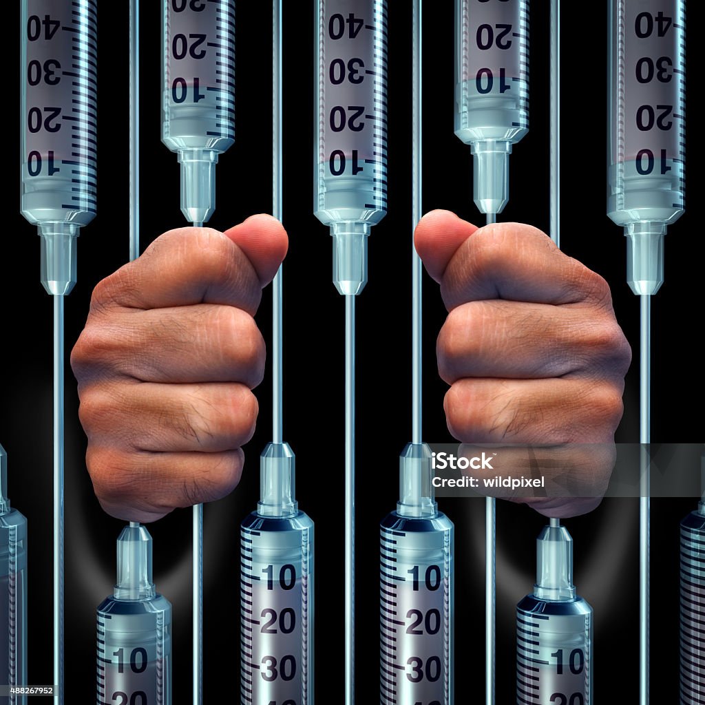 Medical Crime Medical crime concept and criminal doctor malpractice negligence symbol as hands holding a group of syringes as prison or jail bars as an icon for health care trap or medicine addiction. Prison Stock Photo