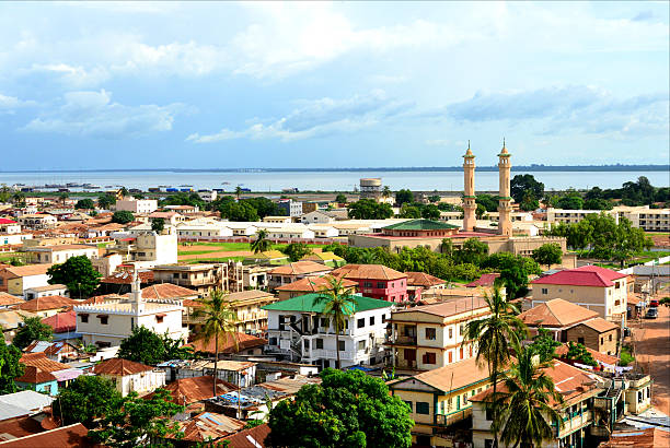 Banjul skyline, The Gambia Banjul, The Gambia: skyline of the low-rise Gambian capital with the River Gambia as Background - minarets of King Fahad Mosque on the right islamic architecture photos stock pictures, royalty-free photos & images
