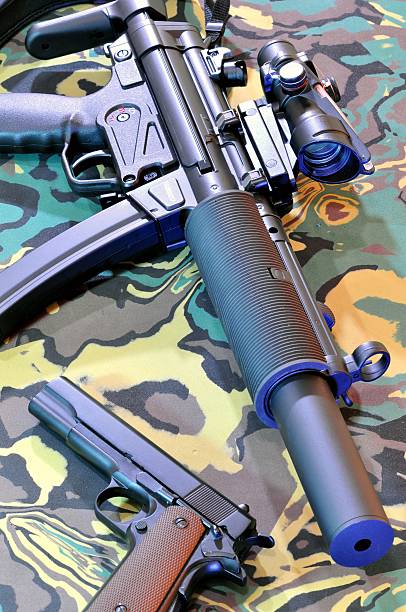 istock Nine millimeter automatic sub-machine gun placed with eleven millimeter semi-automatic pistol. 488269320