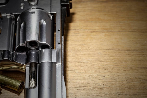 istock close -up air gun on old wood background. 488270162