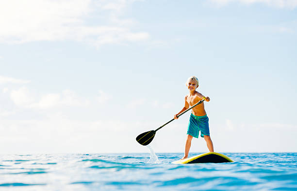 Young Boy Having Fun Stand Up Paddling