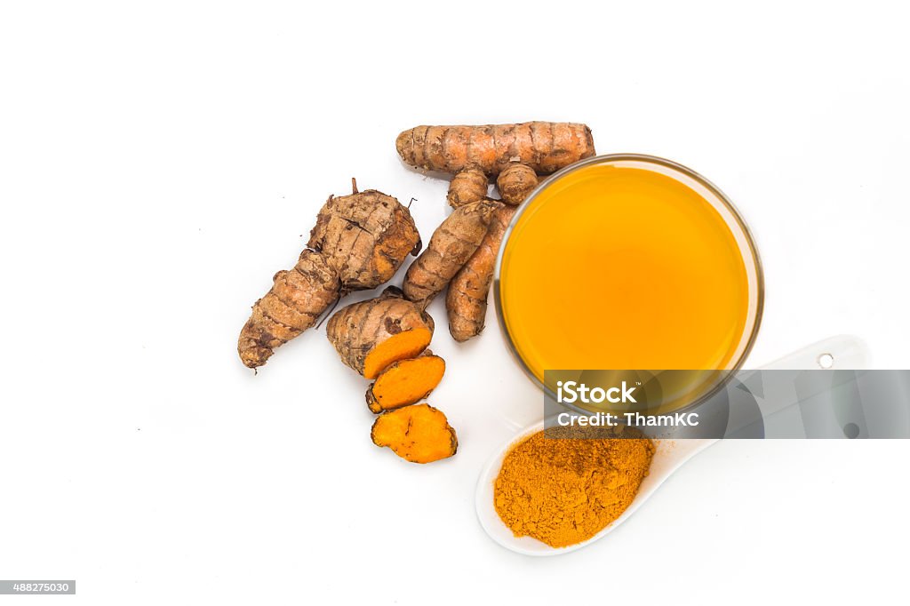 Healthy turmeric roots drinks in a transparent glass. Healthy turmeric roots drinks in a transparent glass 2015 Stock Photo
