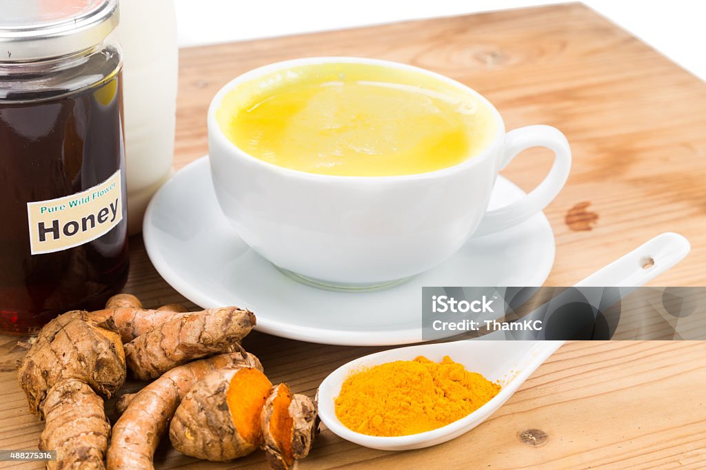 Turmeric roots with milk and honey for beauty and health. Turmeric roots with milk and honey drinks for beauty and health 2015 Stock Photo