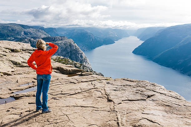 istock Woman hiker on Pulpit Rock / Preikestolen, Norway 488275725
