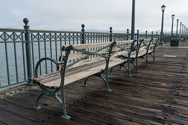 istock Park benches along a wooden pier 488276420