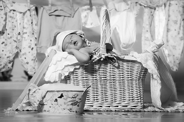 Newborn baby sleeping in a basket after washing stock photo