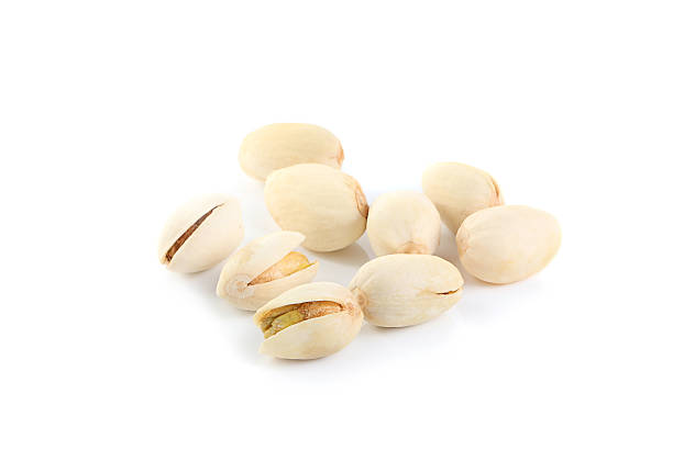 istock pistachios heap against white background 488277396