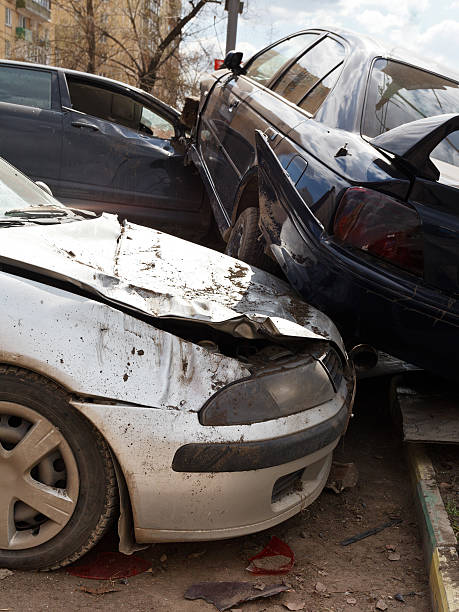 three broken cars during road accident stock photo