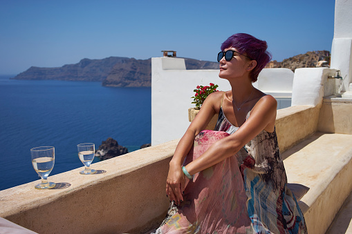 a woman relaxing on patio, Santorini Greece