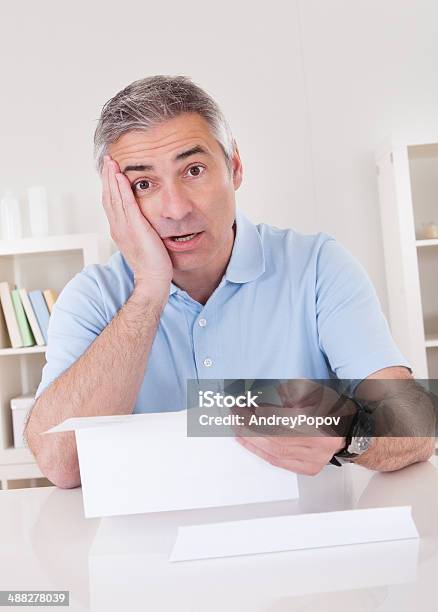 Horrified Old Man Reading A Letter Stock Photo - Download Image Now - Adult, Adults Only, Agreement