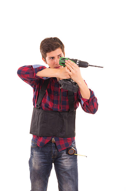 istock man with electric drill on a white background, handyman 488278067