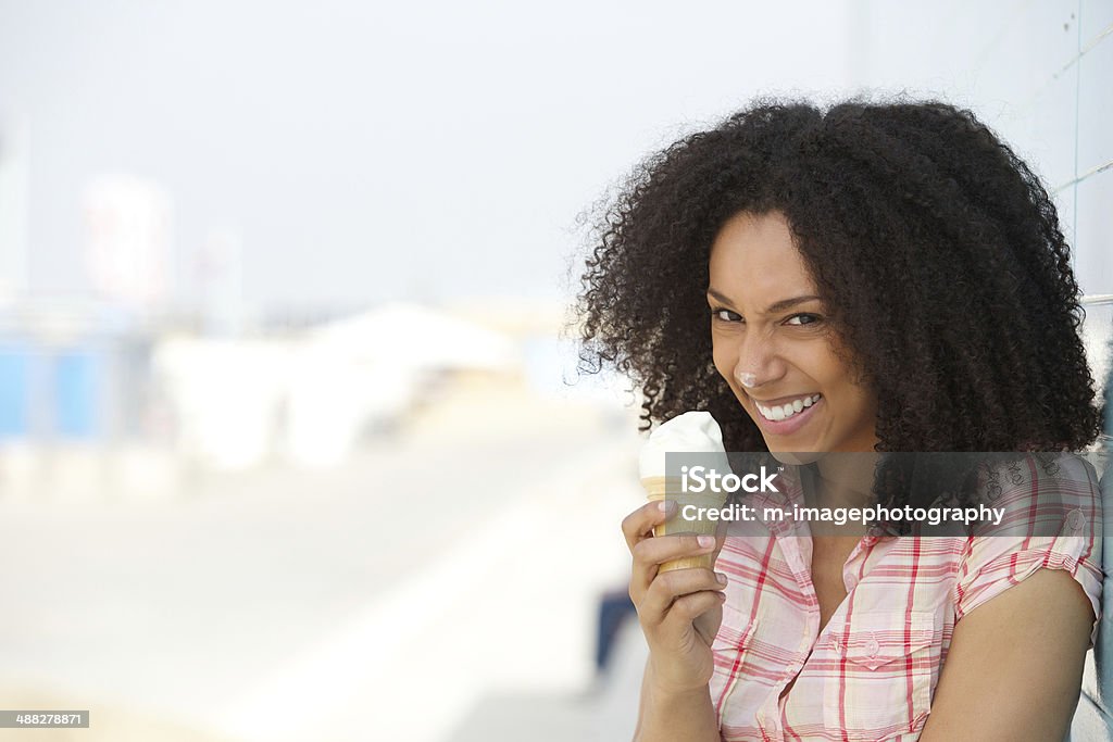 Young woman with ice cream on nose Close up portrait of a fun young woman with ice cream on nose Ice Cream Stock Photo