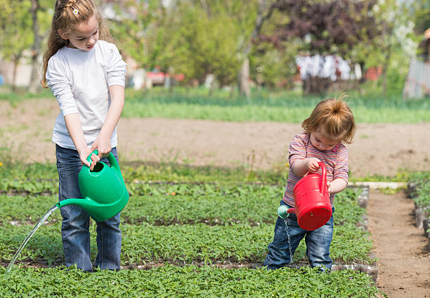 istock little girls watering 488280177