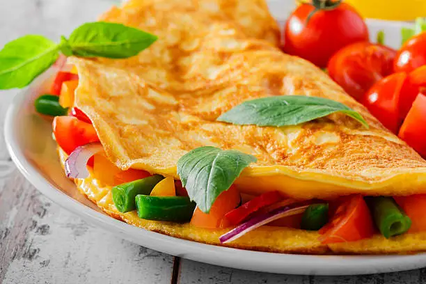 Photo of omelet with vegetables and cherry tomatoes