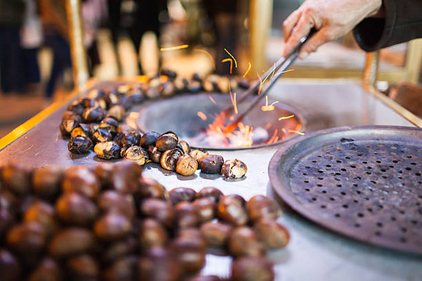 caldarrosta a street - chestnut sweet food yellow group of objects foto e immagini stock