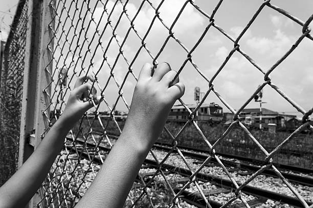 istock Hand girl in jail at Railway Stationsl 488281602