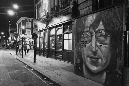 London, UK - September 6, 2015: Black & white image  of John Lennon portrait on the side of the Oxford Arms on Camden High Street at night.