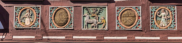 traditional carving at an half timbered house with colored symbols