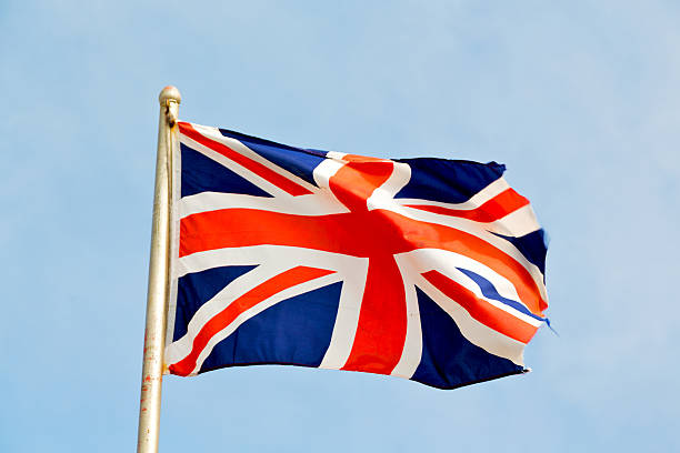 istock waving flag in the blue sky british 488282050