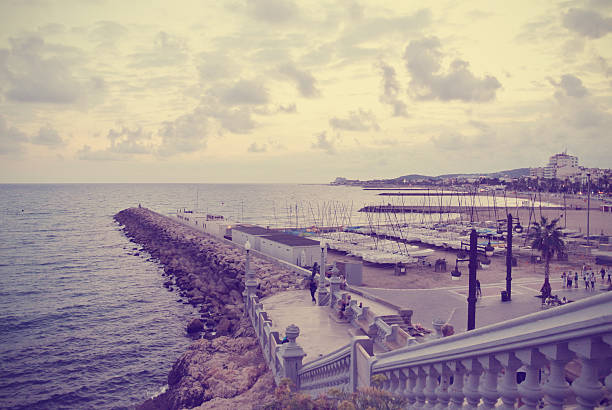 Small marina in the picturesque Spanish seaside resort Sitges, located on Costa Dorada, close to Barcelona in early fall. Image filtered in faded, washed out, retro, Instagram style; nostalgic, vintage concept.