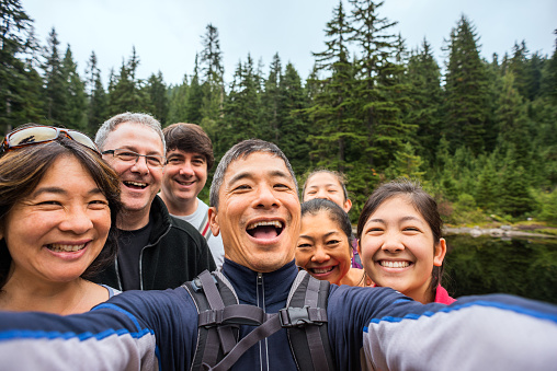 Happy, Extended Multi-Ethnic Family Taking Selfie While Hiking in Woods