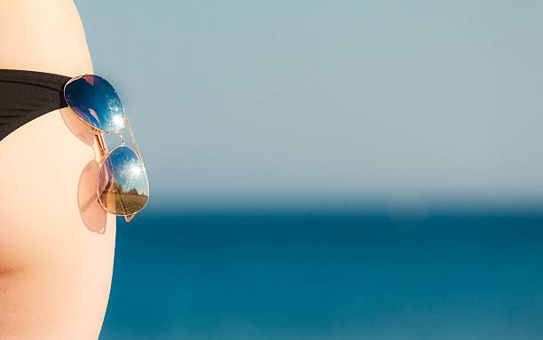 istock Summer vacation. Closeup female buttocks on beach 488283213