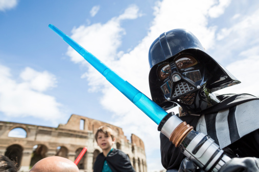Rome, Italy - May 4, 2014: Star Wars Day 2014 in Rome: Darth Vader posing for a photograph in front of the Coliseum