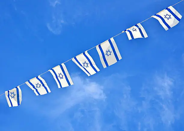 Israel flags in a chain in white and blue showing the Star of David hanging proudly for Israel's Independence Day (Yom Haatzmaut)