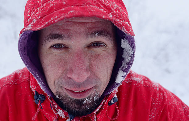 istock Bearded cold and frozen man with a hood on 488306066
