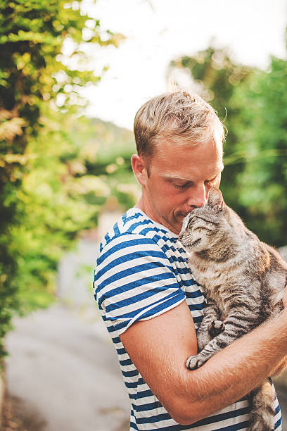 istock Man and cat outdoors in summer 488306617