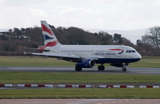 Manchester, United Kingdom - February 16, 2014: British Airways A320 taxiing on Manchester Airport Runway. British Airways is planning to use garbage to power its flights in the future.