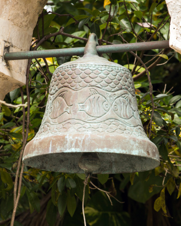 Antique wrought iron bell in mexican village of Playa del Carmen