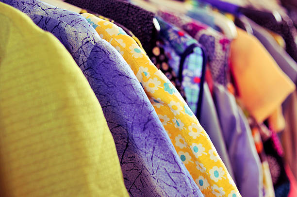 istock clothes hanging on a rack in a flea market 488308104